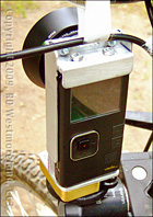 Back View of VadoHD VideoCam Mounted Inside a Custom Metal Bracket, Clamped to a Mountain Bike in Alaska