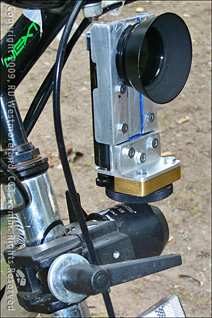 Front View of VadoHD VideoCam Mounted Inside a Custom Metal Bracket, Clamped to a Mountain Bike in Alaska