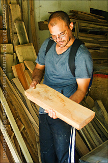 Andres Rua, Technical Director Displaying Board Processed in Their Woodshop on the Grounds of Tropic Ventures Near Patillas, Puerto Rico