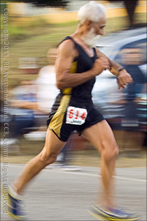 Runner at the 15 Kilometer Mark Checks His Time for the San Blas Half Marathon of Coamo, Puerto Rico