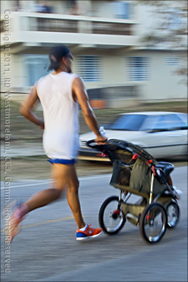 San Blas Marathon Runner With Baby Carriage at 15 Kilometer Mark in Coamo, Puerto Rico