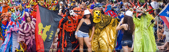 Panoramic Image of Carnival Week Parade in Ponce, Puerto Rico with Colorful Vijigantes