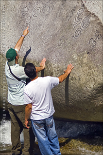 Two Guys Checking Out Taino Indian Rock Glyphs near Jayuya, Puerto Rico