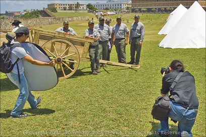 Photographer shooting Park Rangers and Wooden Wagons Built by Park Rangers on the Grounds of El Morro Fort in Old San Juan, Puerto Rico