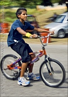 A boy rides his bike before the race.